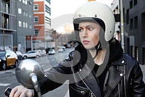 Close-up portrait of biker girl wearing white helmet. Horizontal.