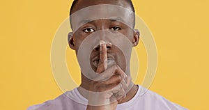 Close up portrait of black man gesturing Shh