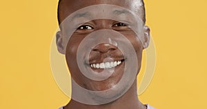 Close up portrait of black man with perfect teeth smiling at camera