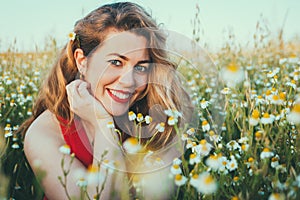 Close up portrait of blonde woman on field of daisies