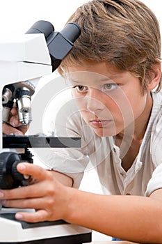 Close up portrait of boy with microscope.