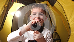 close-up portrait of a boy with a remote control for a toy car