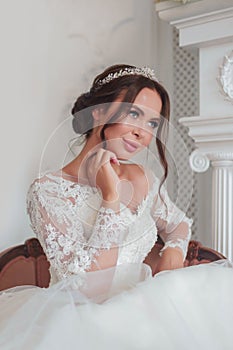 Close-up portrait of a bride in a wedding dress looks mysteriously to the side