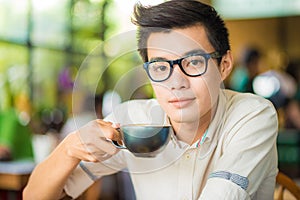 Close up portrait of business asian man drinking coffee in vinta