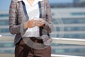 Close up portrait of a business woman holding cell phone