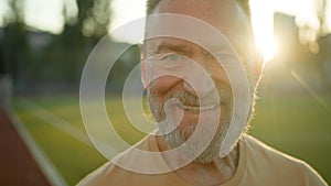 Close up portrait Caucasian cheerful man smiling laughing looking at camera morning city outdoors fun sport sportsman