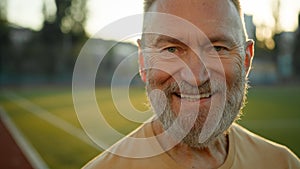 Close up portrait Caucasian cheerful man smiling laughing looking at camera morning city outdoors fun sport sportsman