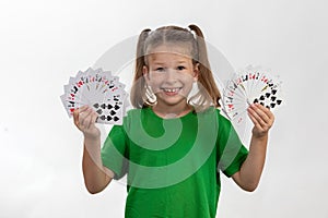 Close up portrait of caucasian girl with playing cards. Isolated on white background. Childhood concept. Free time, fun, hobby,