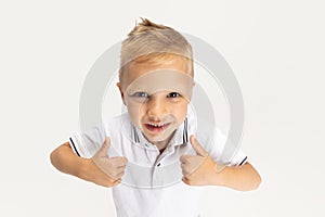 Close-up portrait of Caucasian preschool boy isolated on white studio background. Copyspace for ad. Childhood, education