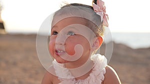 Close-up portrait of charming pretty baby girl enjoying taste of healthful watermelon on family picnic outdoors in