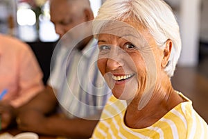 Close-up portrait of cheerful biracial senior woman with african american man in nursing home