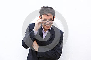 Cheerful older businessman with spectacles smiling against white background