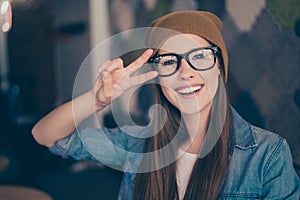 Close up portrait of cheerful playful girl, who is gesturing pea