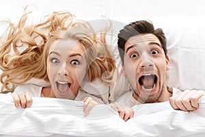 Close up portrait of a cheerful young couple screaming