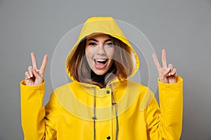Close up portrait of a cheery girl dressed in raincoat