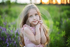 Close-up portrait child praying. Little girl hand praying, hands folded in prayer concept for faith, spirituality and religion. Cu