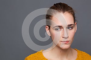 Concerned young woman thinking, expressing doubt, insecurity, suspicion or distrust photo