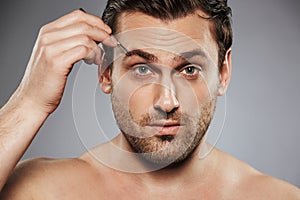 Close up portrait of a confident shirtless man