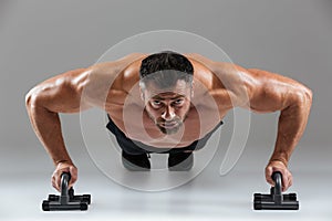 Close up portrait of a confident strong shirtless male bodybuilder