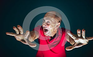 Close up portrait of crazy scared and shocked man isolated on dark background