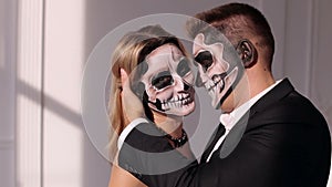 Close-up portrait of a creepy girl with makeup in the form of a skull.