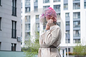 Close-up portrait of curly Caucasian woman with multi-colored hair. Model for hairstyles