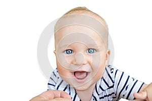 Close-up portrait of cute caucasian baby boy smiling and having fun with parents outdoors. Happy infant face with big blue eyes,sw