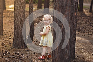 Close-up portrait of cute cheerful little girl in park