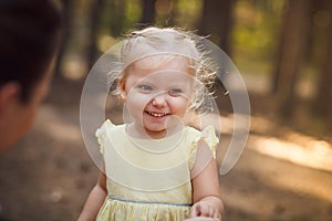 Close-up portrait of cute cheerful little girl in park