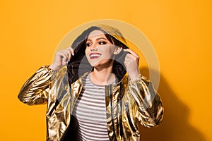 Close up portrait of cute excited model in golden stylish coat w