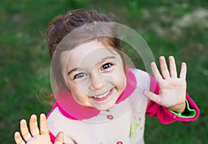 Close up portrait of cute happy little girl smiling to the camera