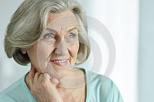 Close-up portrait of cute happy senior woman posing