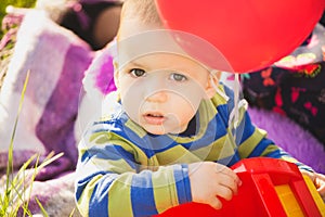 Close up portrait of cute little baby boy playing with toys