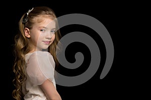 Close-up.Portrait of a cute little girl on a black background.