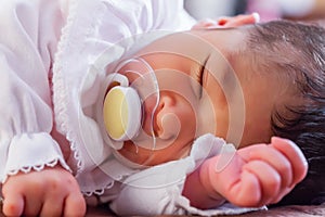 Close up portrait of a cute two weeks old newborn baby girl