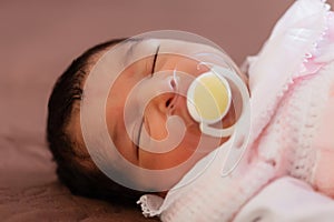 Close up portrait of a cute two weeks old newborn baby girl