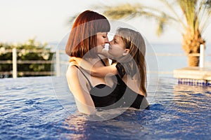 Close up portrait of a daughter and her mother together in a vacation villa on the sea