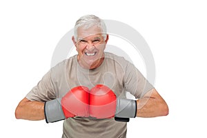 Close-up portrait of a determined senior boxer