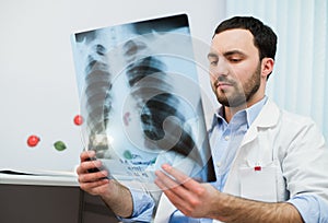 Close up portrait of doctor looking at chest x ray in his office