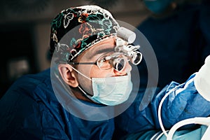 Close up portrait of doctor performing surgery operation in sterile surgery room