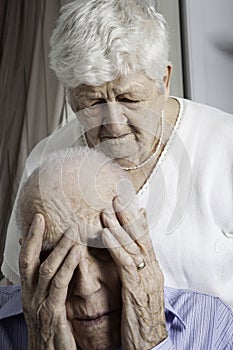 Close-up portrait of an elder couple at home