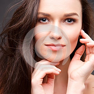 Close up portrait of elegant brunette woman with nude make up