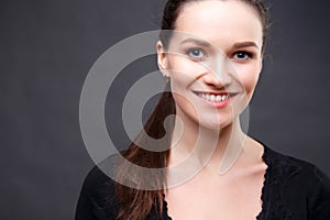 Close up portrait of elegant brunette woman with nude make up