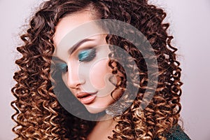 Close up portrait of elegant luxurious woman in trendy green sequin party dress . Elegant wavy hairstyle, bright make up