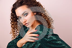 Close up portrait of elegant luxurious woman in trendy green sequin party dress . Elegant wavy hairstyle, bright make up