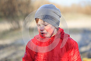 Close-up portrait of an emotional boy in a bad mood