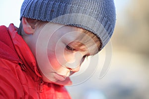 Close-up portrait of an emotional boy in a bad mood