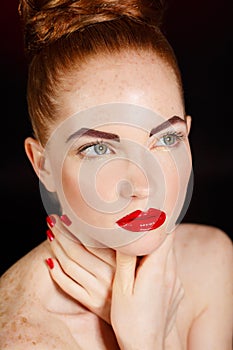 Close-up portrait of european young woman model with glamour make-up and red bright manicure. christmas makeup, bloody red li