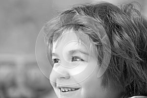 Close up portrait of an excited little boy laughing.