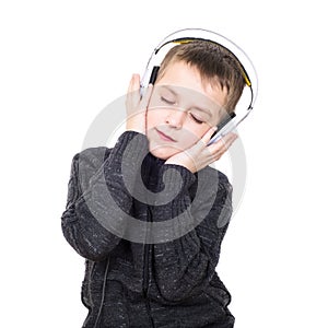 Close up portrait of eyes closed boy listening to music with headphones